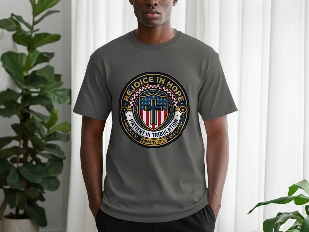 Gray t-shirt with "Rejoice in Hope Patient in Tribulation" circular emblem and cross.