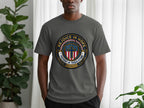 Gray t-shirt with "Rejoice in Hope Patient in Tribulation" circular emblem and cross.