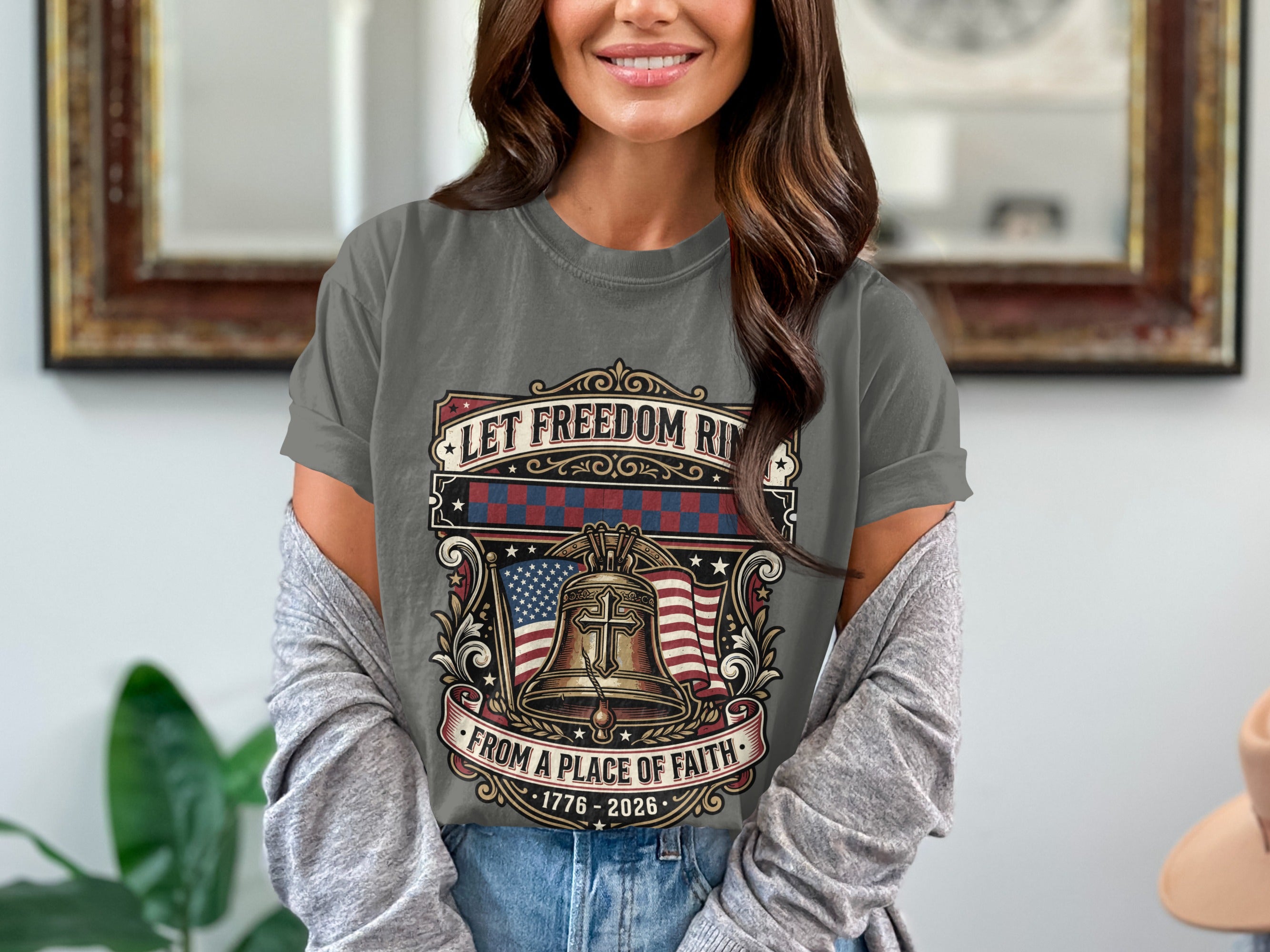 Grey t-shirt with Liberty Bell, American flag, and text "Let Freedom Ride from a Place of Faith 1776-2026".