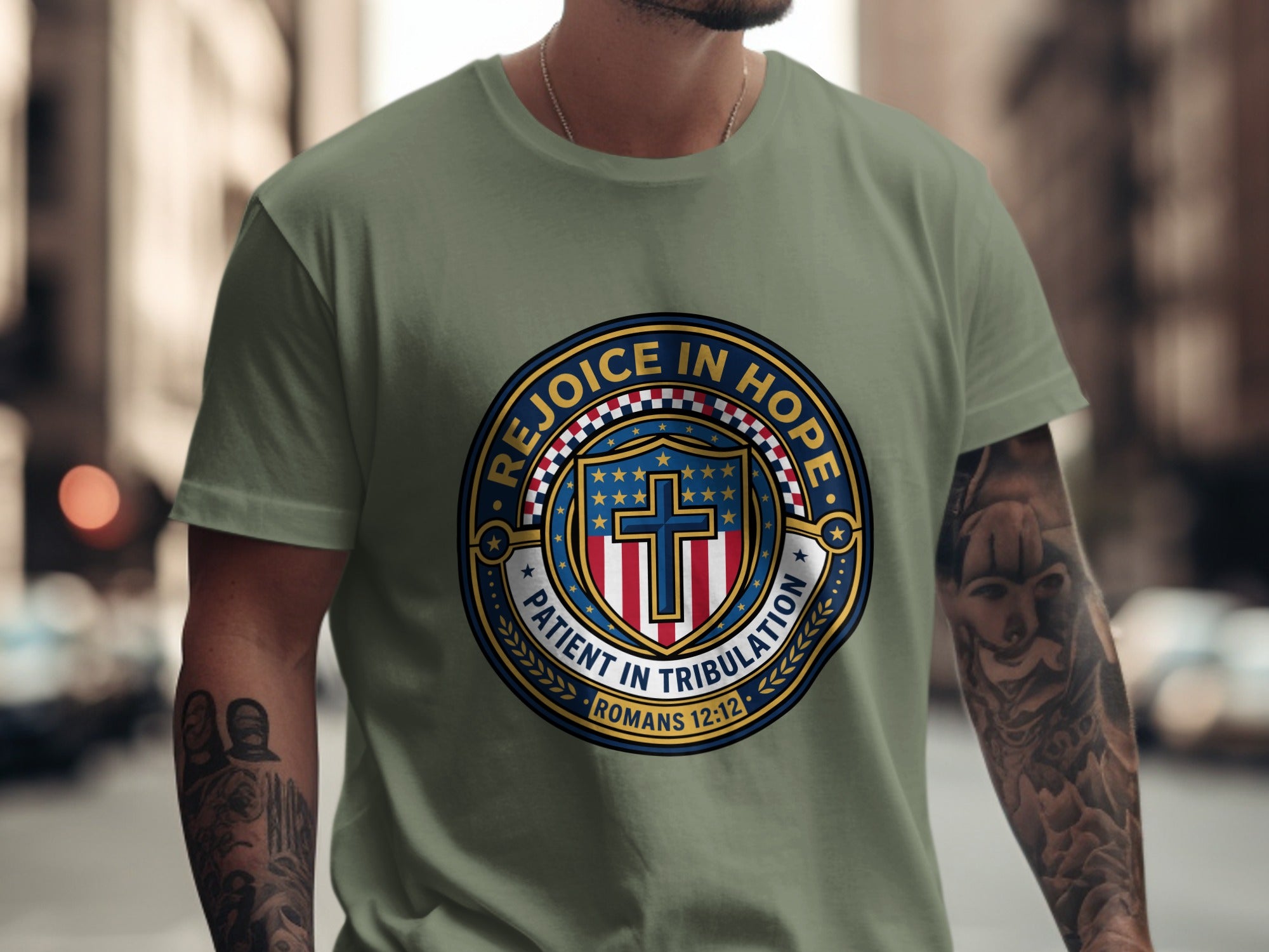 Olive green t-shirt with a circular emblem featuring a cross and text.