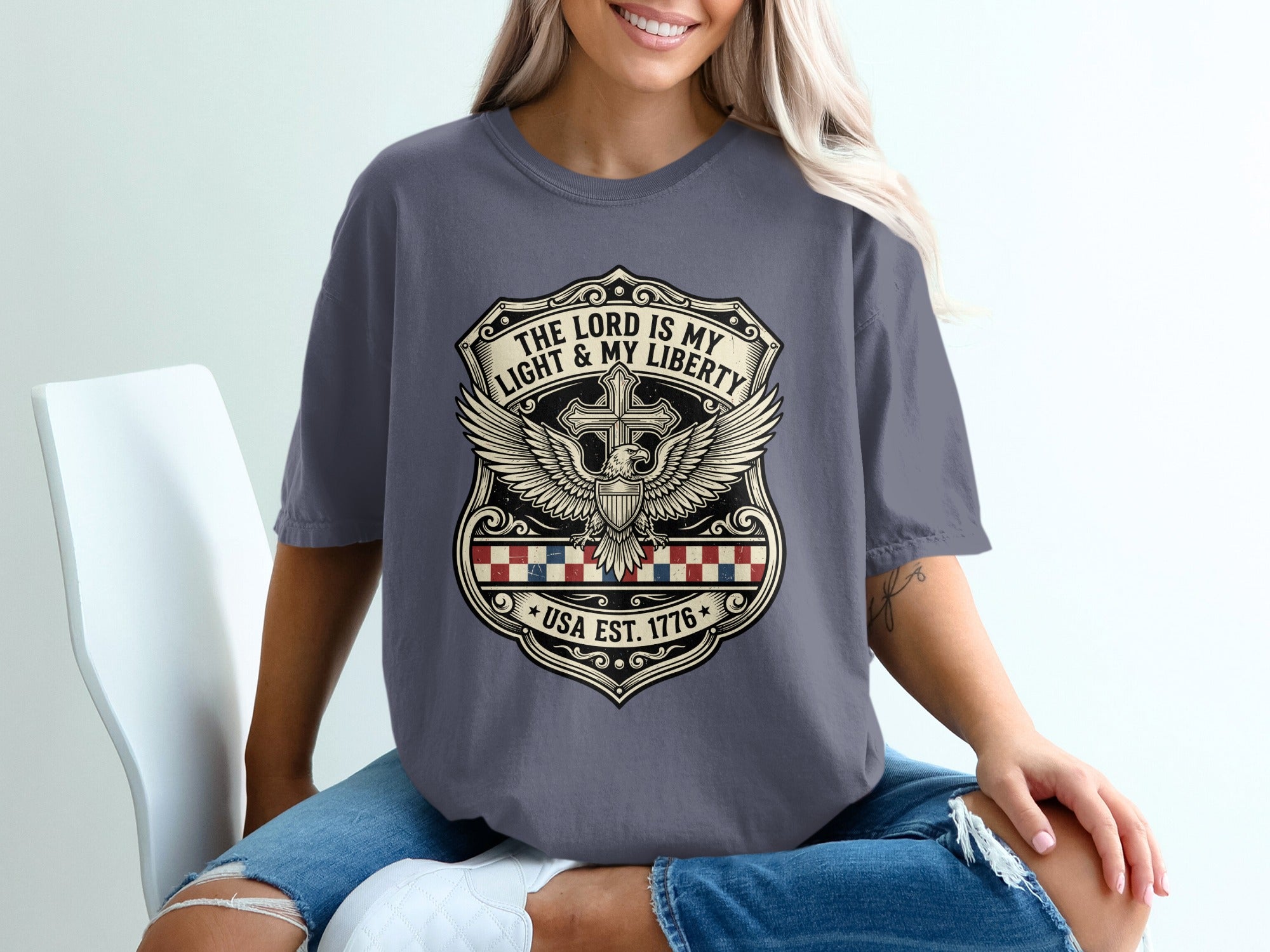 Dark grey t-shirt with shield design, cross, wings, and text.