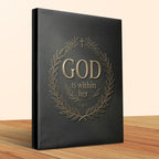 Black book with gold lettering "GOD IS within her" and laurel wreath.