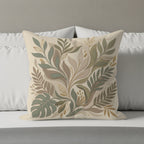Square throw pillow with a botanical leaf pattern in earthy tones.