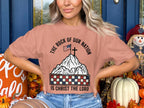 Peach t-shirt with "The Rock of Our Nation Is Christ the Lord" and American flag on mountain.