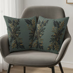 Two gray throw pillows with a gold and dark green floral design on a gray chair.