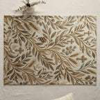 Tapestry placemat with gold and green botanical and cross pattern.