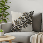 Textured throw pillow with a raised olive branch design on a sofa.