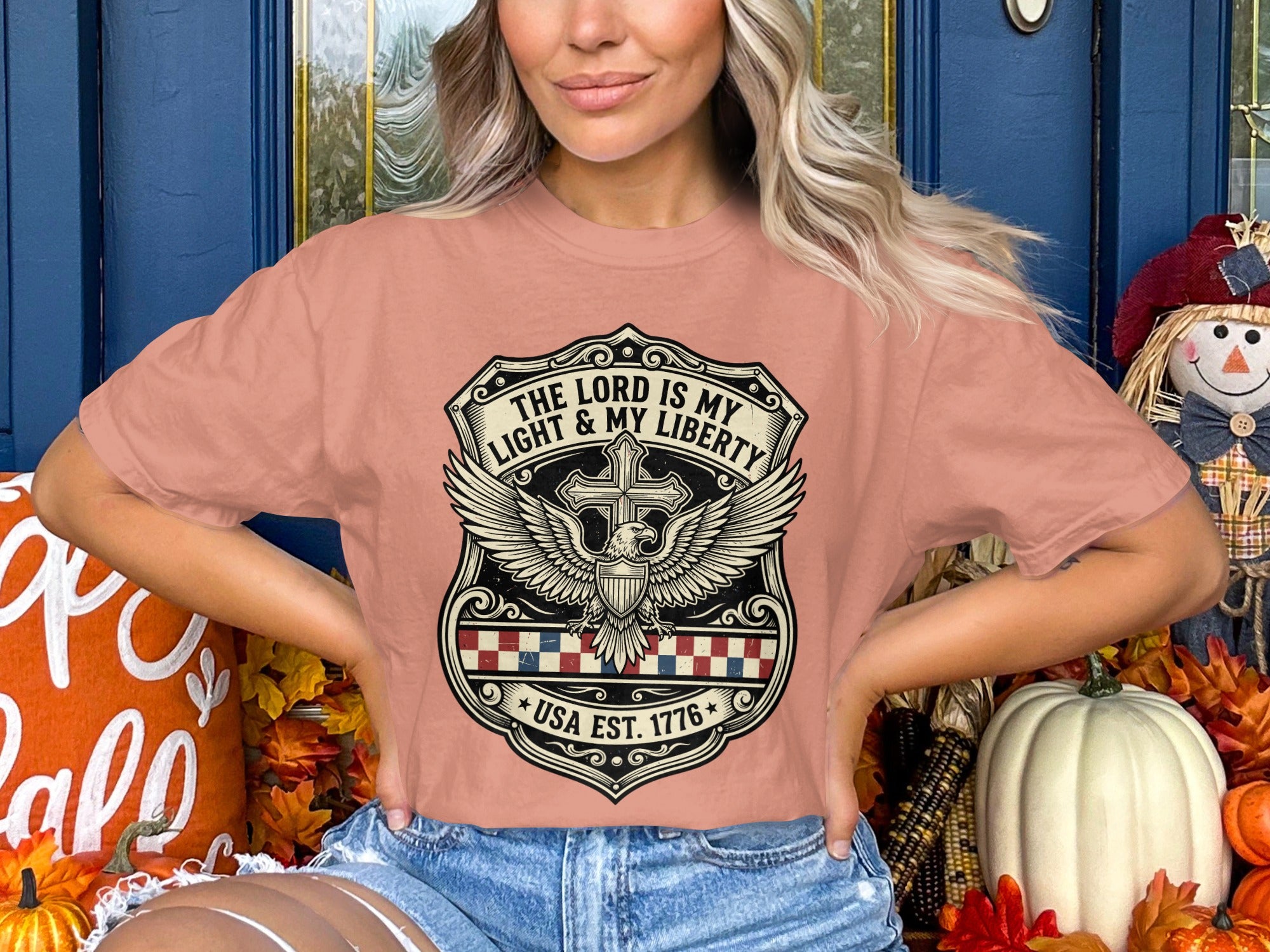 T-shirt with "The Lord is My Light & My Liberty USA Est. 1776" emblem.