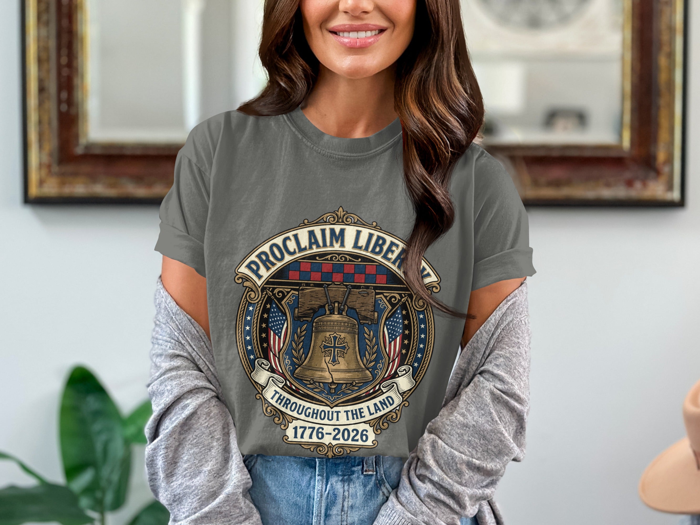 Gray t-shirt featuring the Liberty Bell, American flags, and "Proclaim Liberty Throughout the Land 1776-2026".