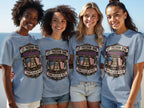 Four women wear gray t-shirts with a bell, flag, and text: "Let Freedom Ring."