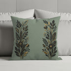 Sage green decorative pillow with gold and black floral embroidery.