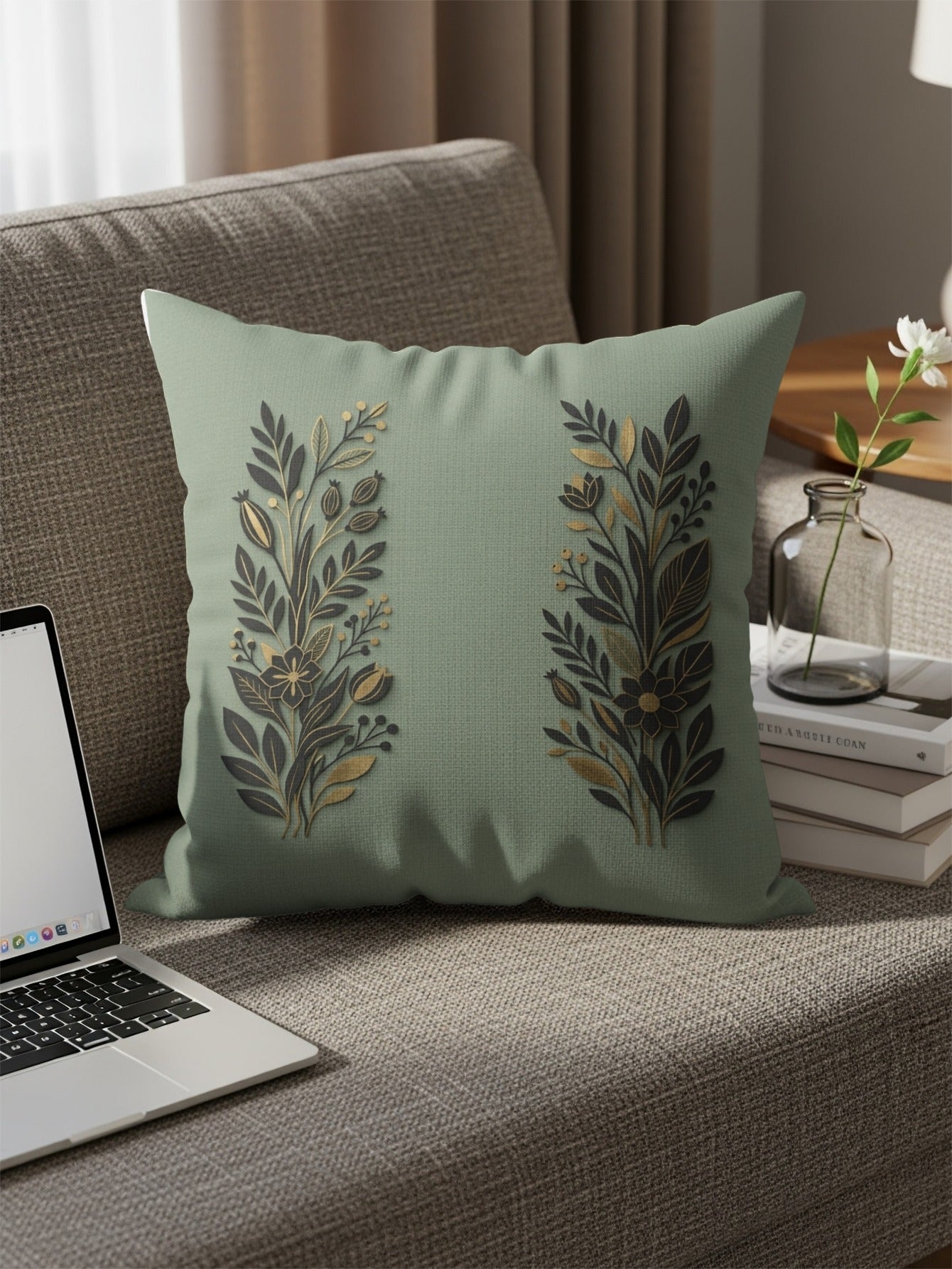 Light green throw pillow with gold and dark green floral branch design.