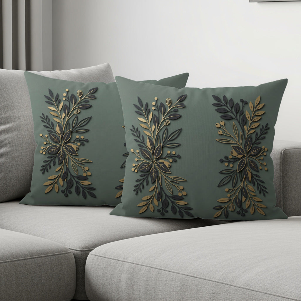 Two dark green throw pillows with a metallic gold and black floral branch design.