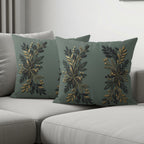 Two dark green throw pillows with a metallic gold and black floral branch design.