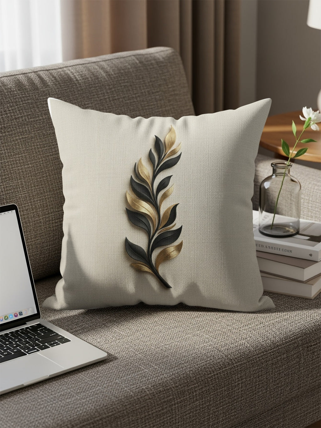 Cream cushion with a raised gold and black leaf design on a sofa.