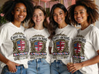 Four women wear white t-shirts with "Christ the King" and a shield design.