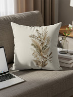 Pillow with dried botanicals print on a couch with a laptop.