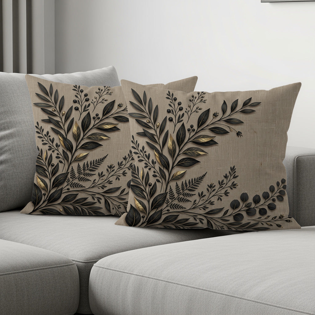 Two beige throw pillows with a dark floral pattern arranged on a sofa.