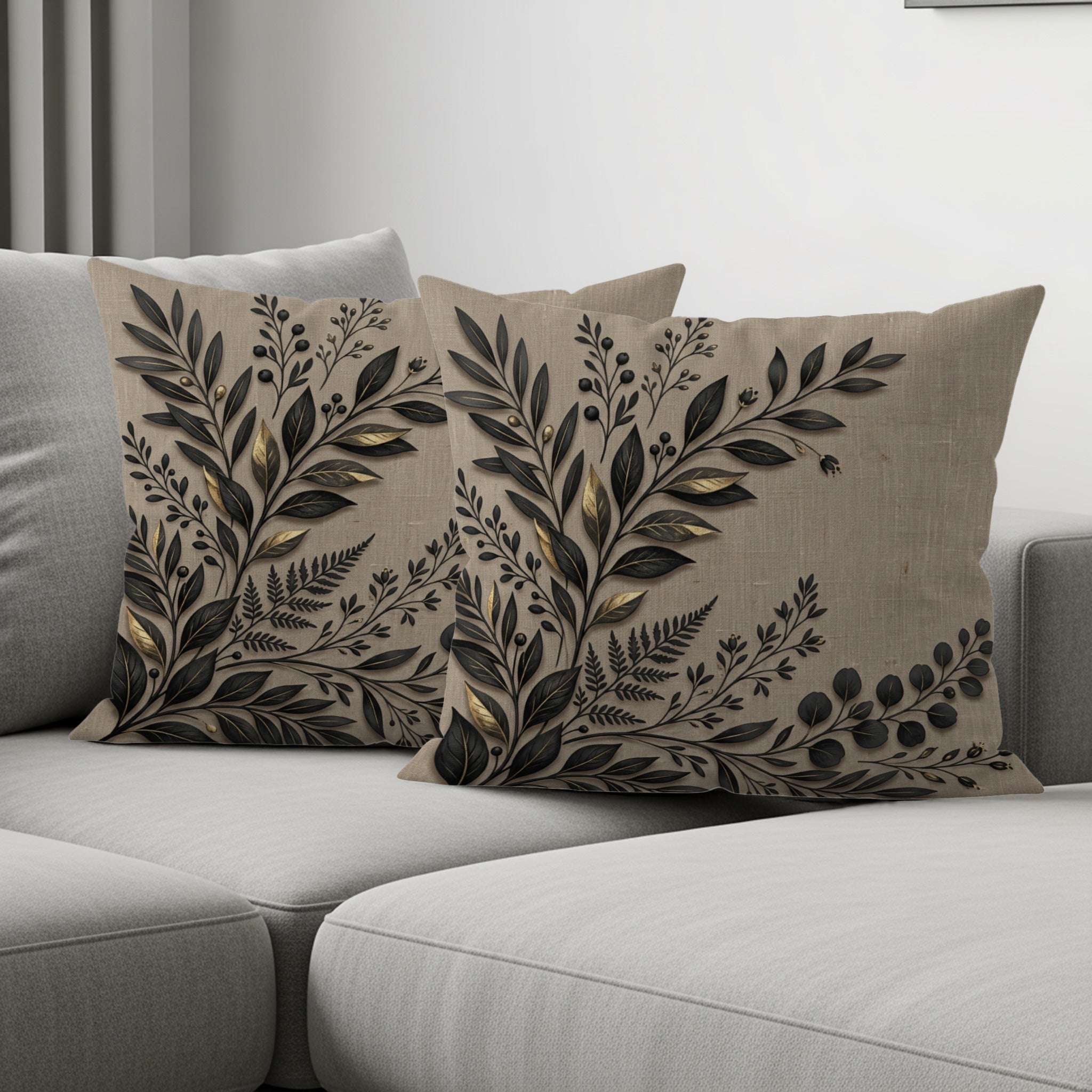 Two beige throw pillows with a dark floral pattern arranged on a sofa.