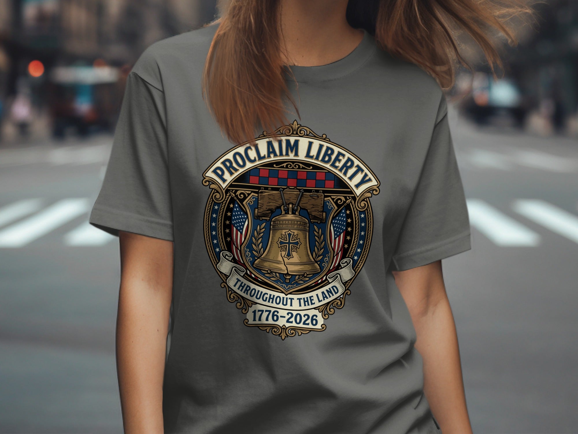 Gray t-shirt with a "Proclaim Liberty" bell logo featuring American flags and "1776-2026."