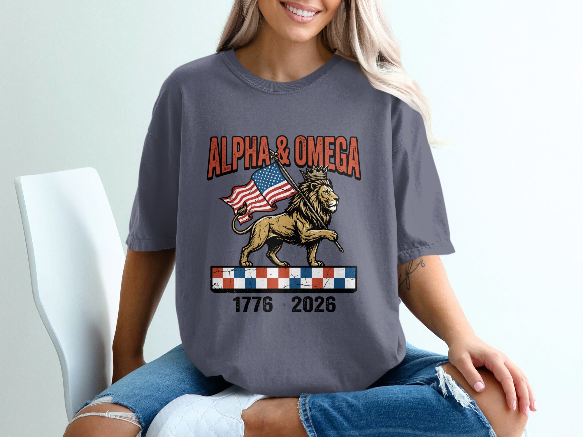 T-shirt with lion wearing crown, holding American flag, "Alpha & Omega" text.