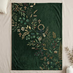 Green fleece blanket with botanical print and small crosses.