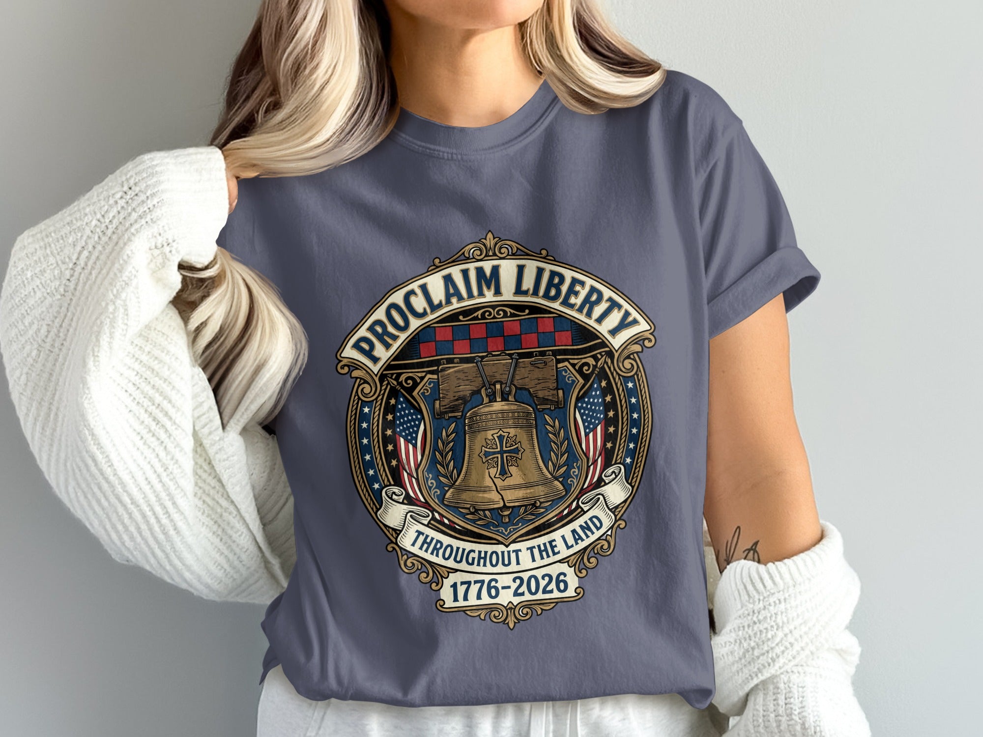 Bell with American flags and "Proclaim Liberty Throughout the Land 1776-2026".
