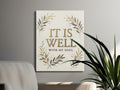 Canvas art with "It Is Well With My Soul" text and gold leaf design.