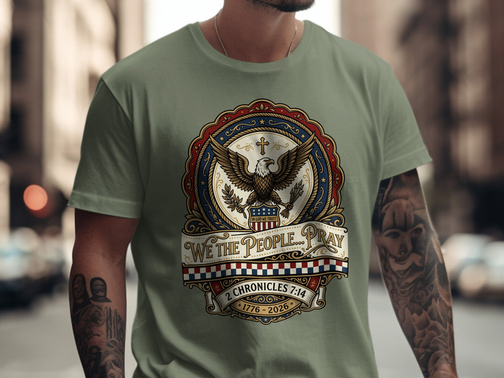 Olive green t-shirt with eagle, patriotic seal, and "We the People Pray" text.