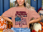 Pink t-shirt with "Blessed is the Nation" text and American flag design.