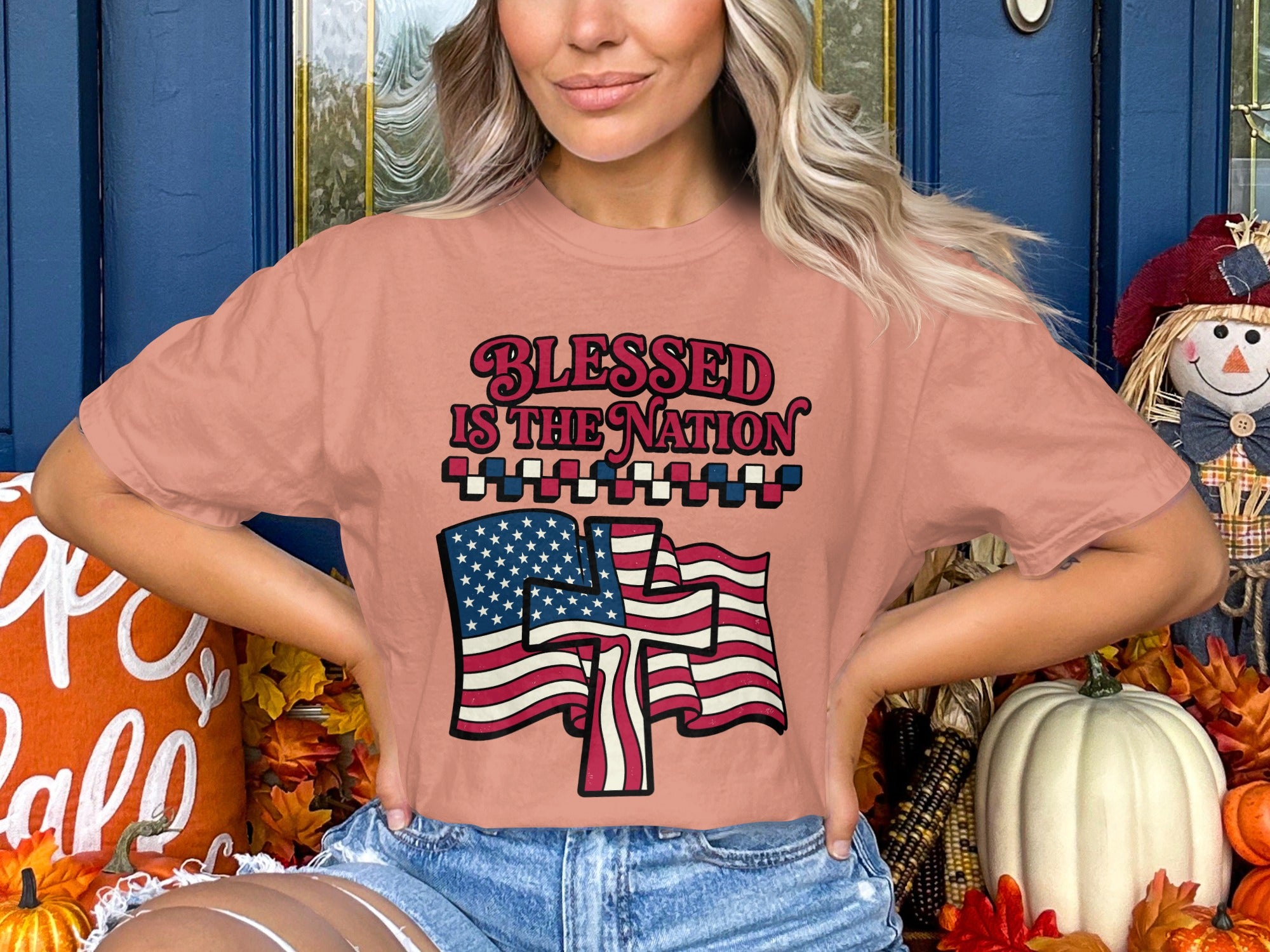 Pink t-shirt with "Blessed is the Nation" text and American flag design.