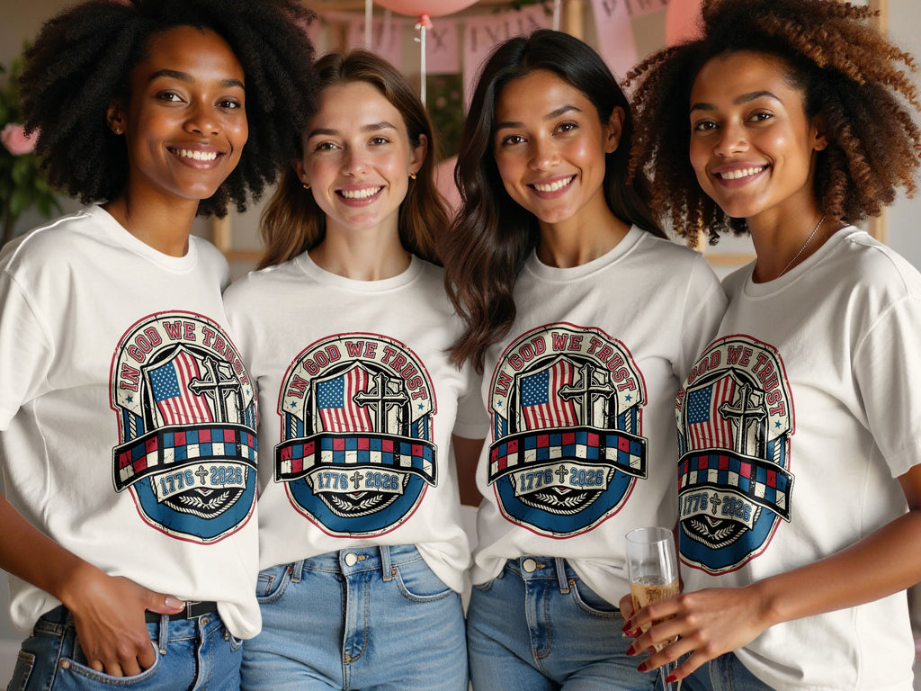 Four women wear matching "In God We Trust" t-shirts with American flag and cross graphic.