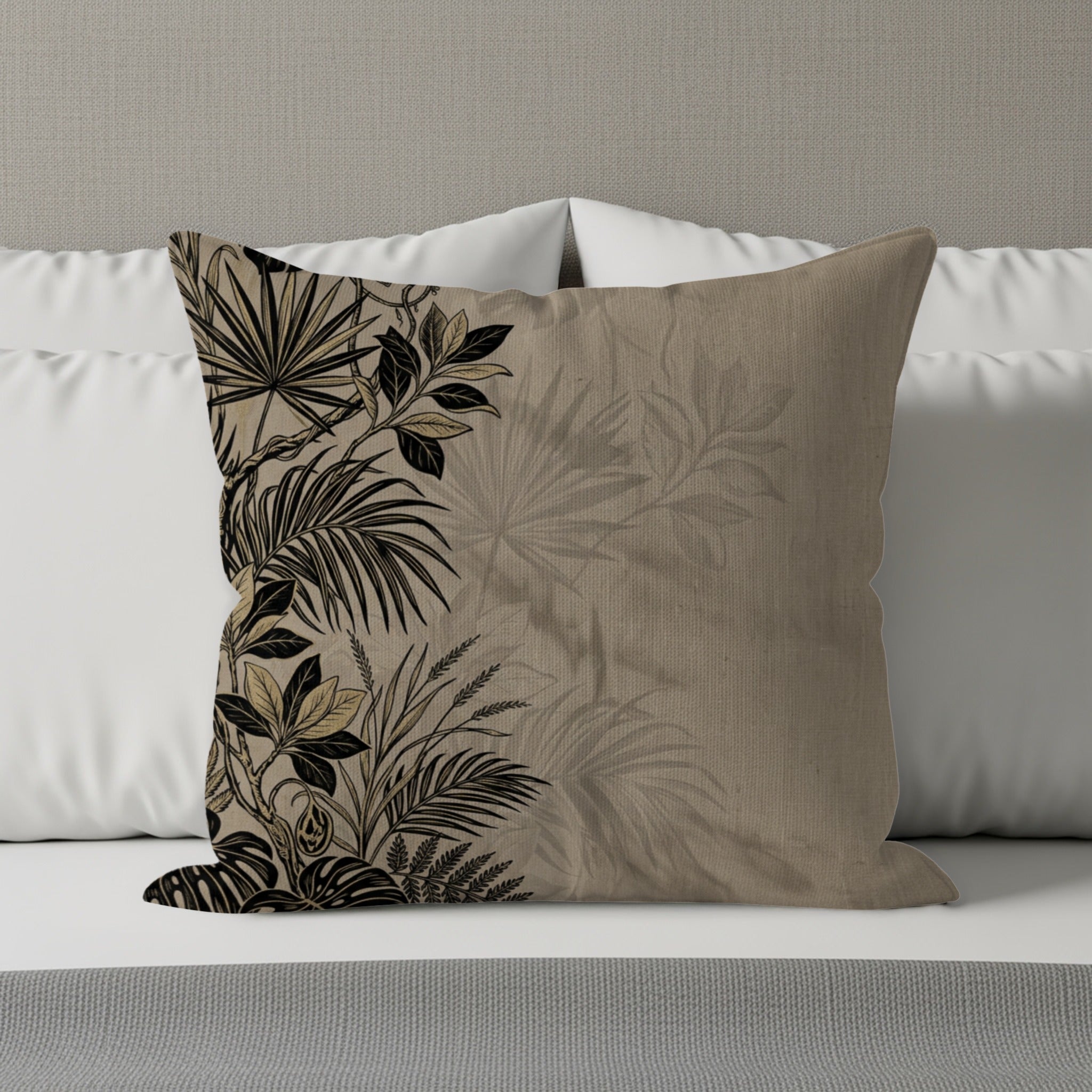 Tapestry cushion with black and gold tropical leaf pattern on a beige background.