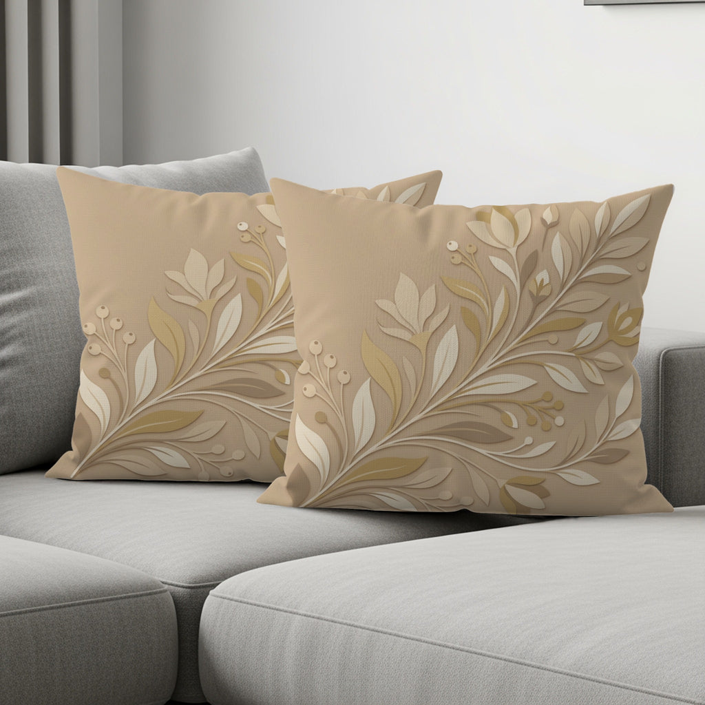 Beige decorative throw pillows with floral embroidery on a gray couch.
