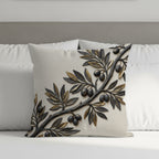 Textured throw pillow with raised olive branch design on neutral fabric.