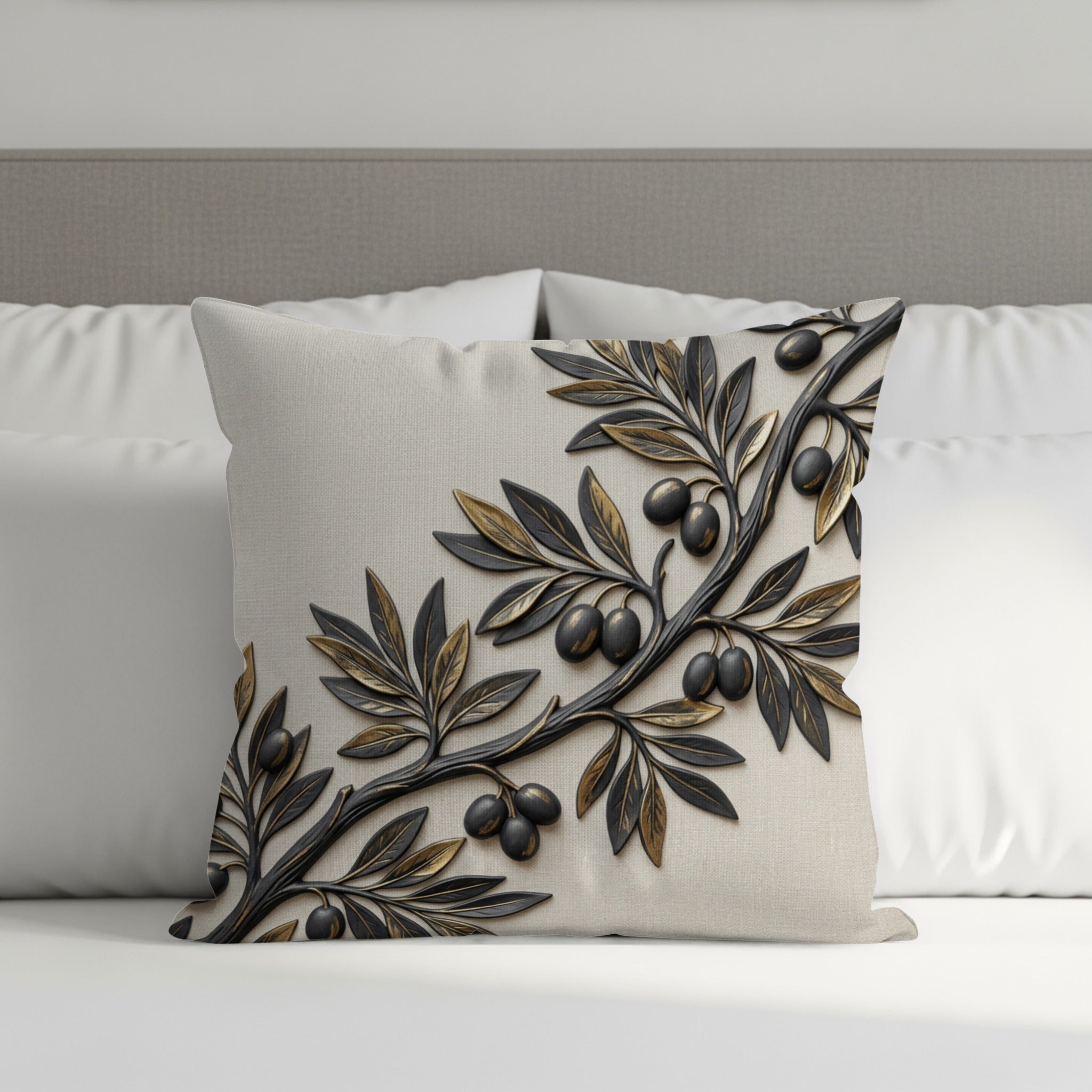Textured throw pillow with raised olive branch design on neutral fabric.