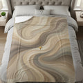 Abstract beige and brown wavy pattern with a golden cross on a bed.