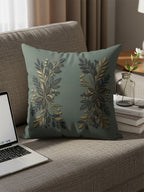 Green throw pillow with gold and black floral botanical design.