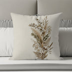 Floral bouquet design on a textured cream pillow with gray and white bedding.