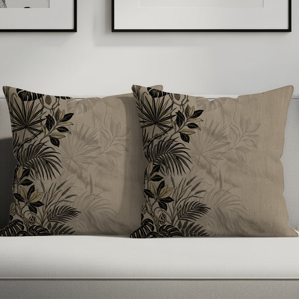 Two throw pillows with botanical print on a couch.