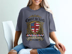 Gray t-shirt with "Christ the King" shield design and American flag.
