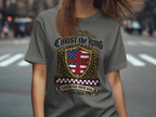Grey t-shirt with shield, cross, and text "Christ the King Sovereign Over USA 1776-2026".