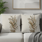 Two decorative throw pillows with dried floral and botanical patterns.
