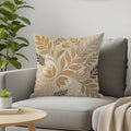 Throw pillow with neutral floral pattern on a gray sofa.