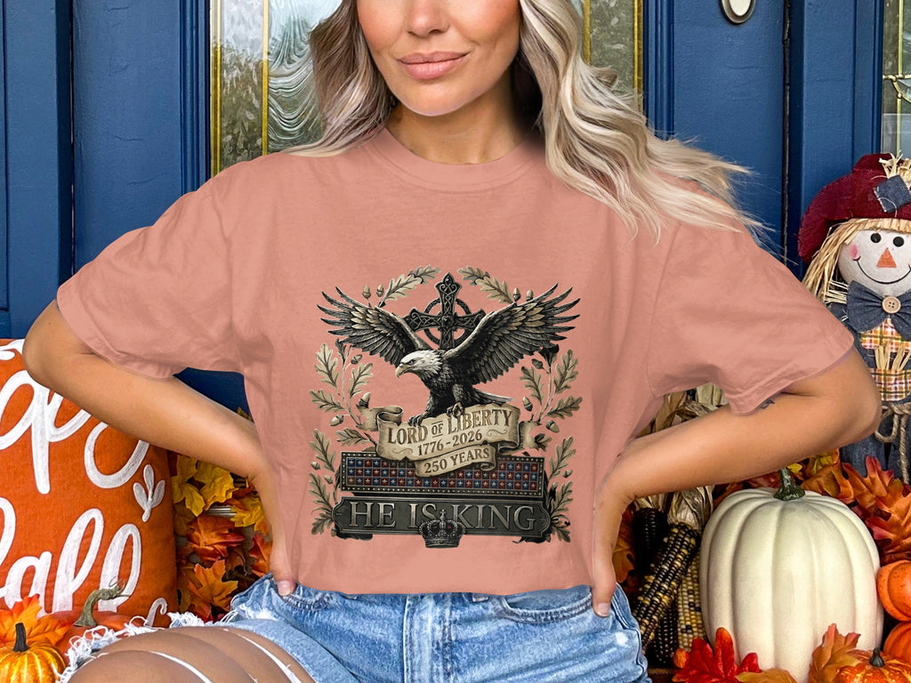 Peach crop top with eagle, cross, and text "Lord of Liberty 1776-2026 250 Years HE IS KING".