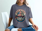 T-shirt with "In God We Trust" emblem featuring American flag and cross.