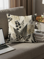 Couch pillow with fern and leaf botanical pattern.