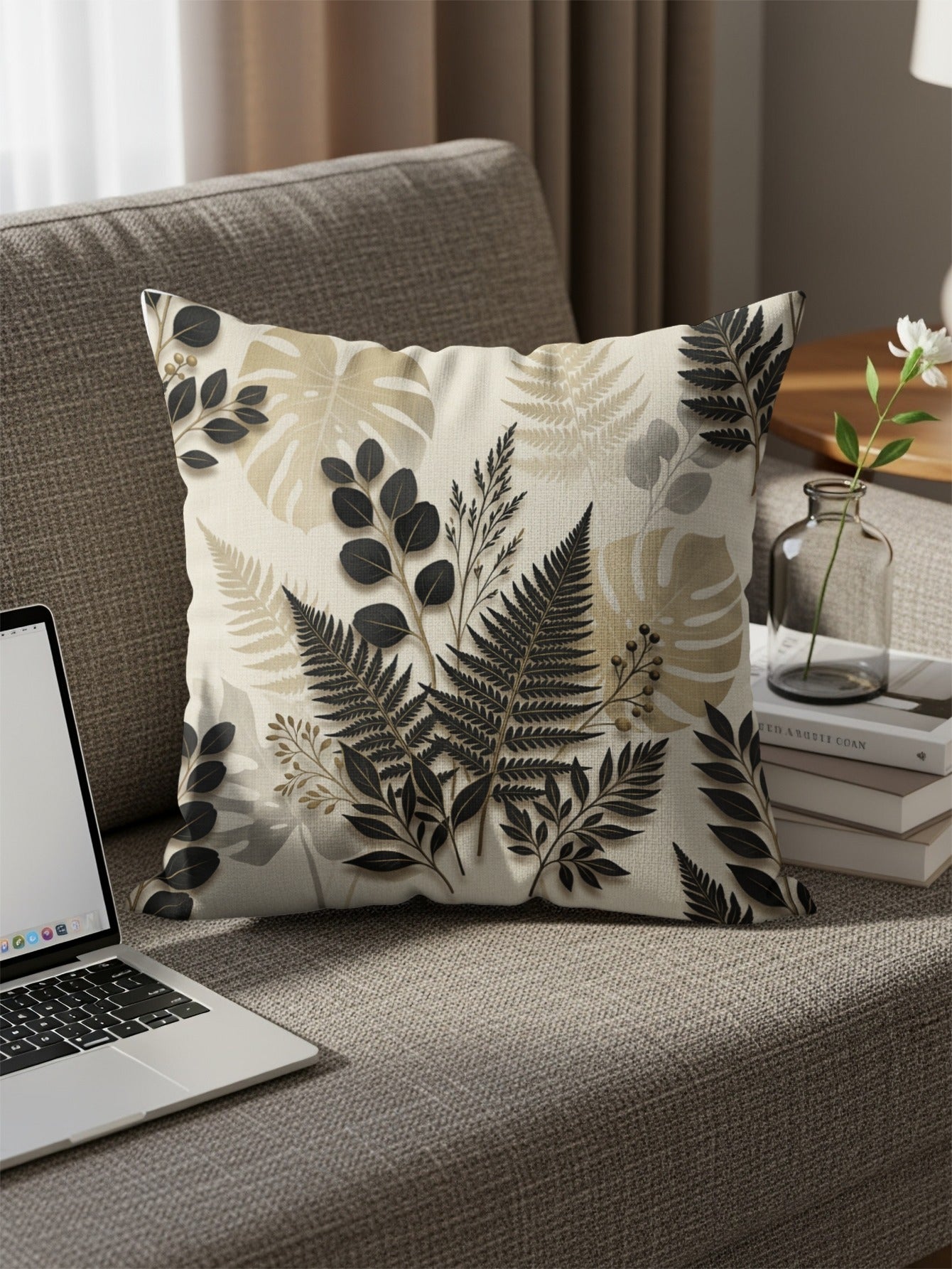 Couch pillow with fern and leaf botanical pattern.