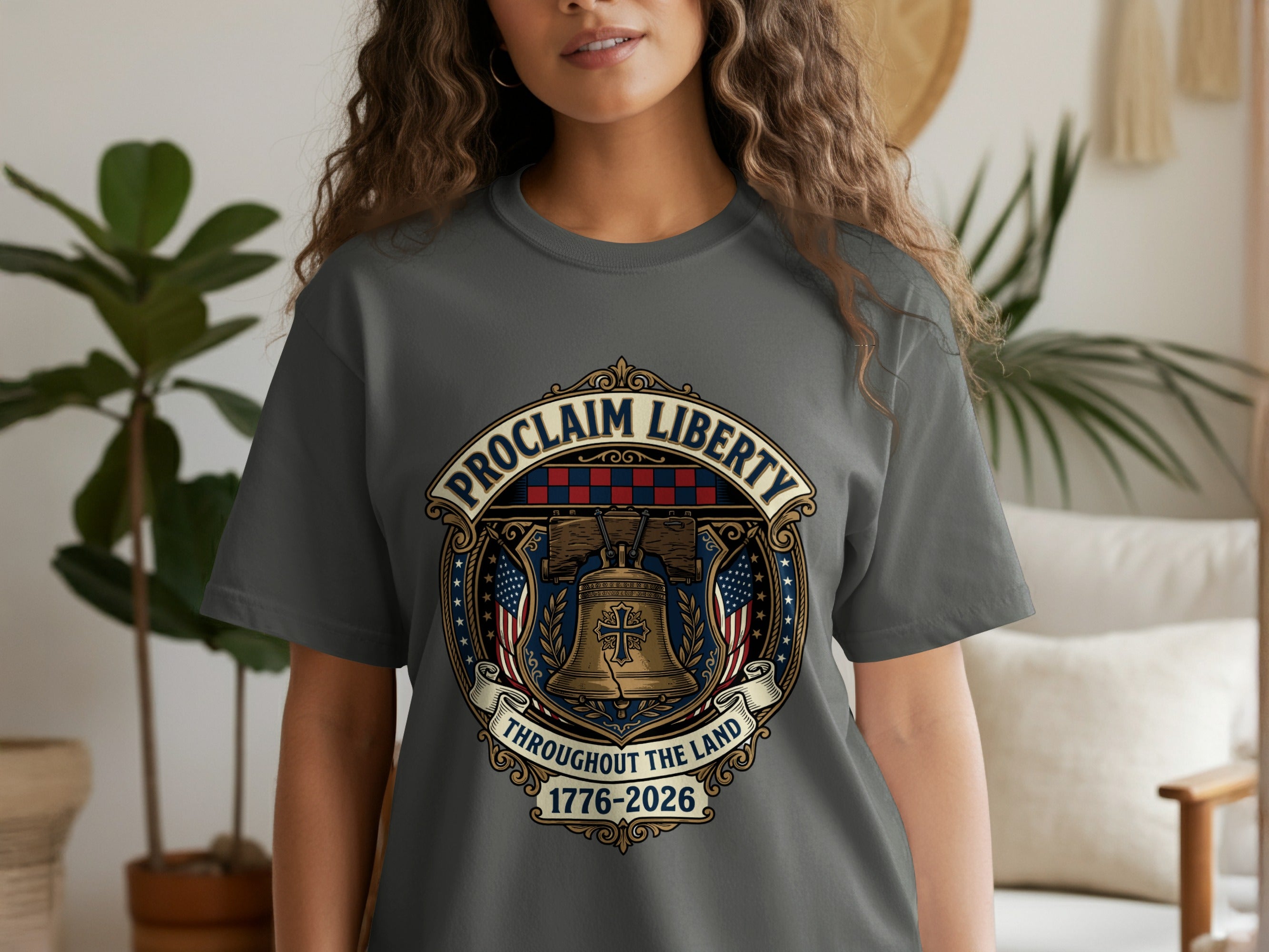 Gray t-shirt with a patriotic emblem featuring a bell and American flags.