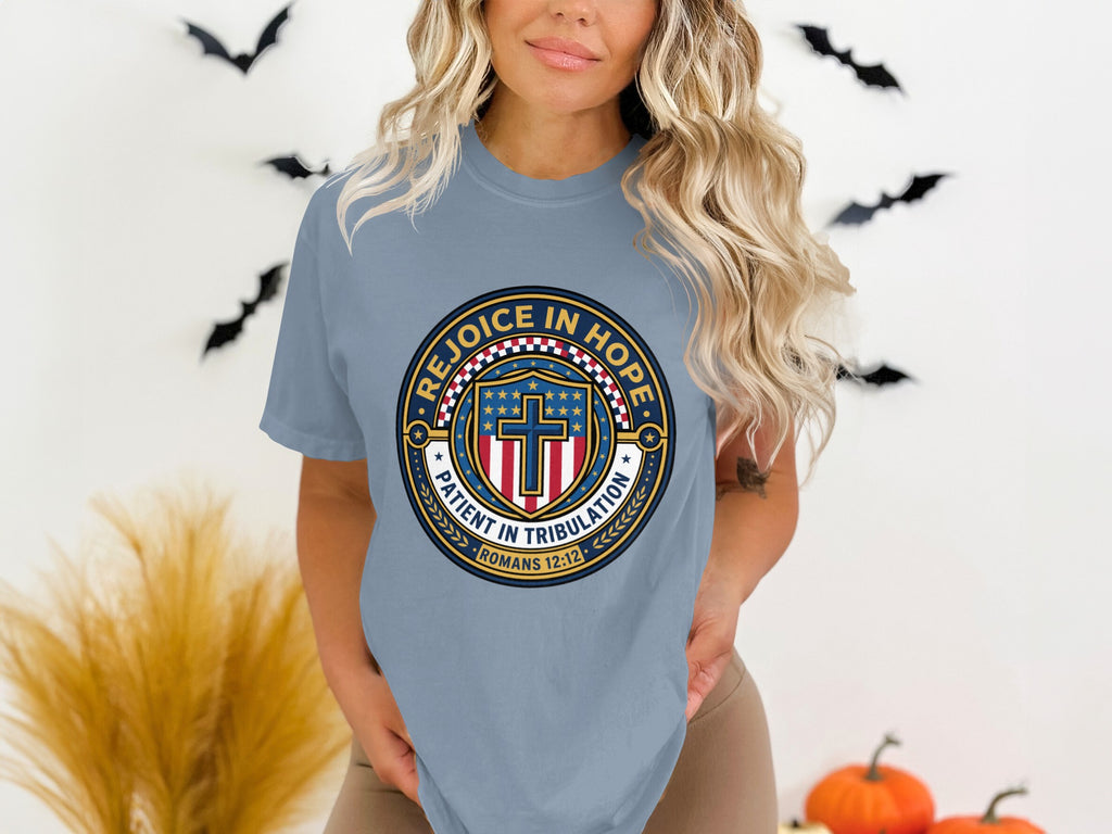 Light blue t-shirt with "Rejoice in Hope" emblem featuring a cross and shield.